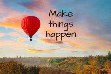 Image of Make things happen, affirmation. Bright hot air balloon flying over countryside