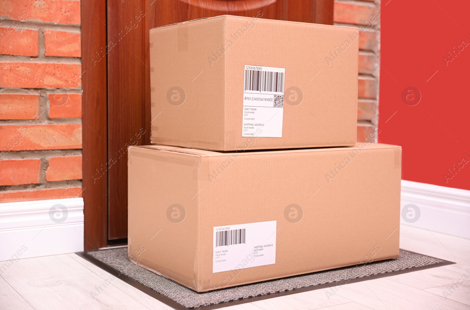 Photo of Parcels on rug near door. Delivery service