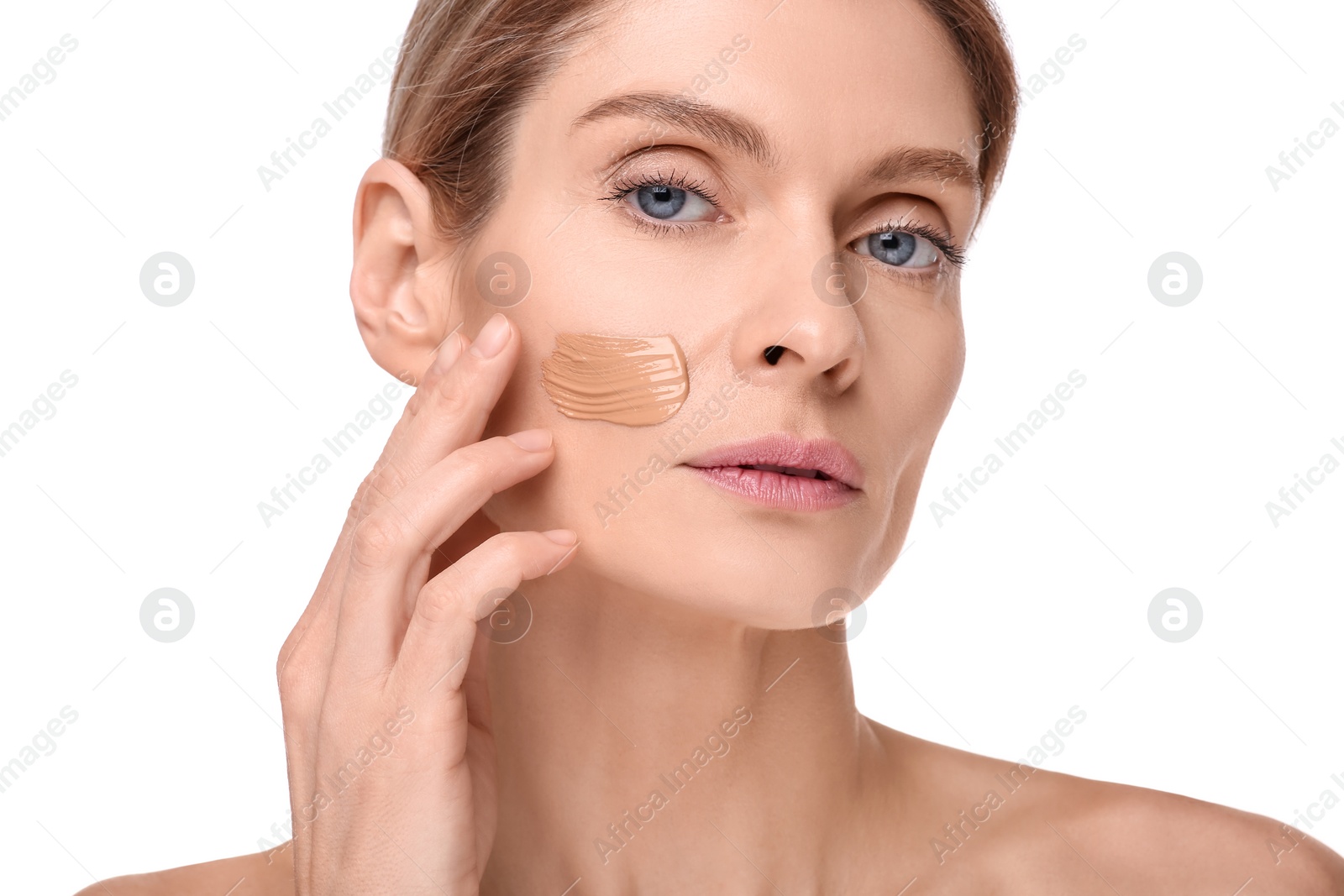 Photo of Woman with swatch of foundation on face against white background