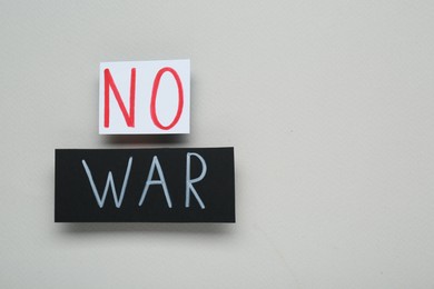 Photo of Cards with words No War on light grey background, top view. Space for text