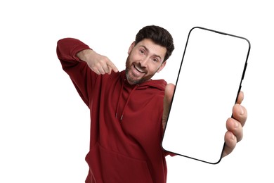 Happy man holding smartphone with empty screen on white background