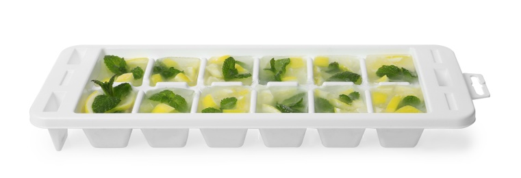Photo of Ice cubes with lemon and mint in tray on white background