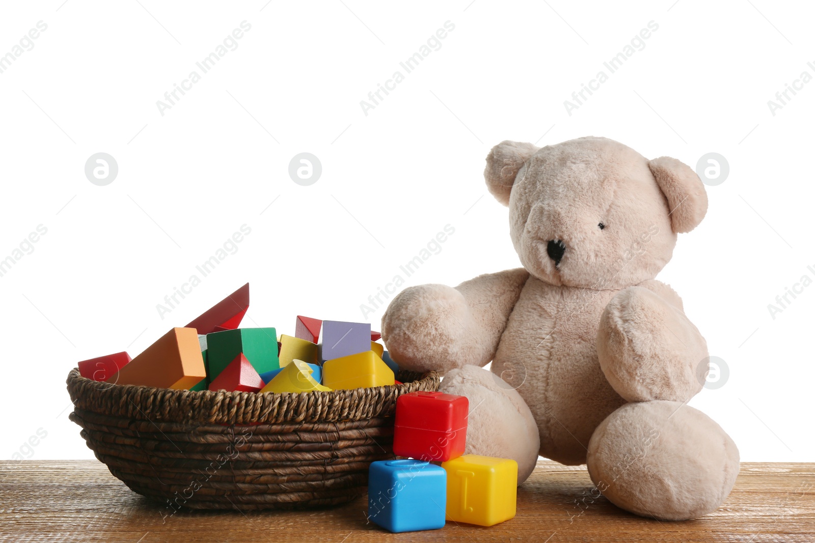 Photo of Set of different toys on wooden table against white background