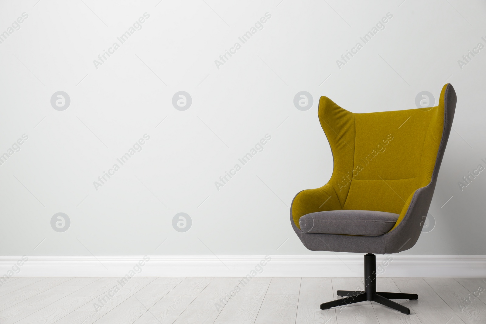 Photo of Comfortable office chair near light wall indoors. Space for text