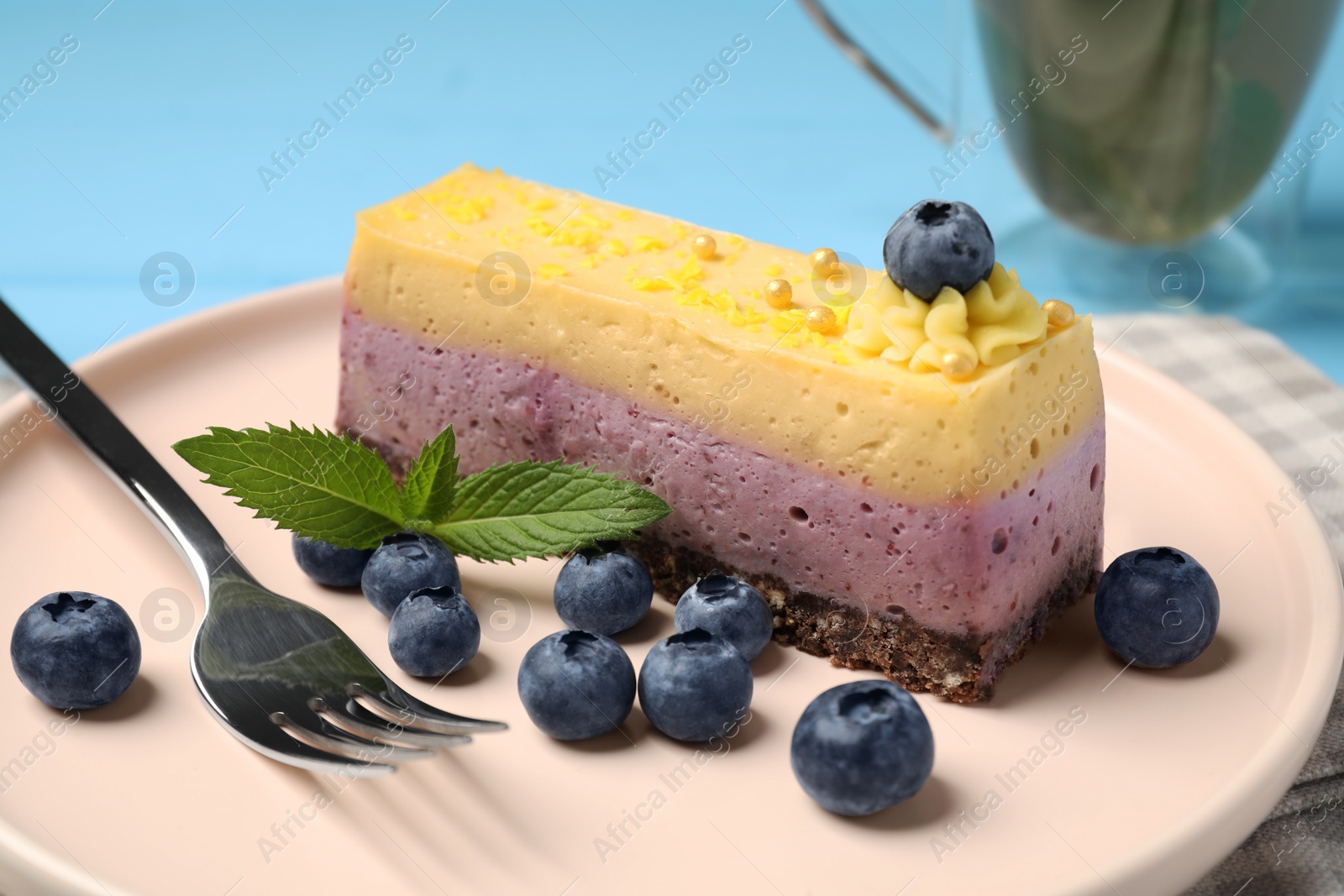 Photo of Delicious cheesecake with blueberry and mint on plate, closeup