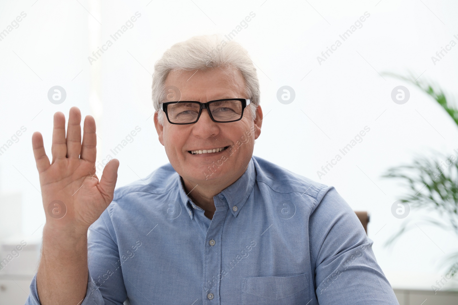 Photo of Mature man using video chat indoors, view from web camera