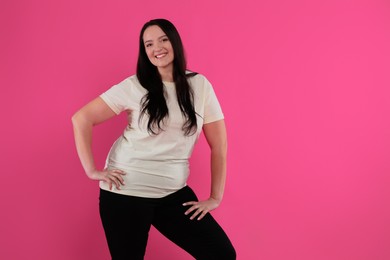 Photo of Beautiful overweight woman with charming smile on pink background. Space for text