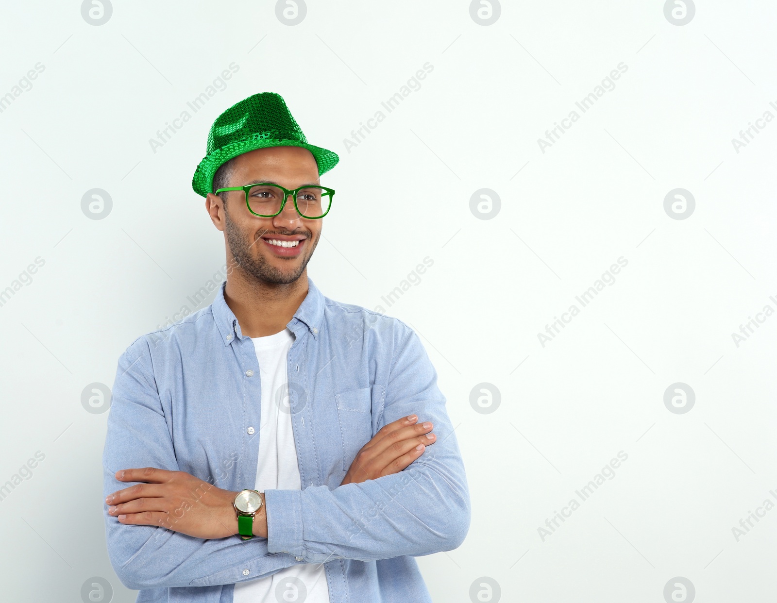 Image of St. Patrick's day party. Man with green leprechaun hat on light background. Space for text