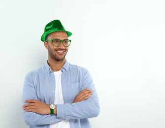 St. Patrick's day party. Man with green leprechaun hat on light background. Space for text