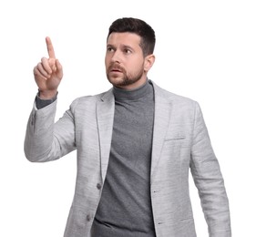 Handsome bearded businessman in suit pointing at something on white background