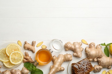 Photo of Ginger, honey and lemon on white wooden table, flat lay with space for text. Natural cold remedies