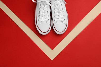 Photo of Stylish sneakers on color background, flat lay