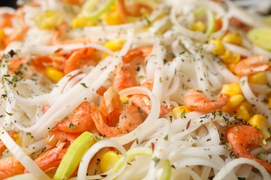 Photo of Rice noodles with shrimps and vegetables as background, closeup
