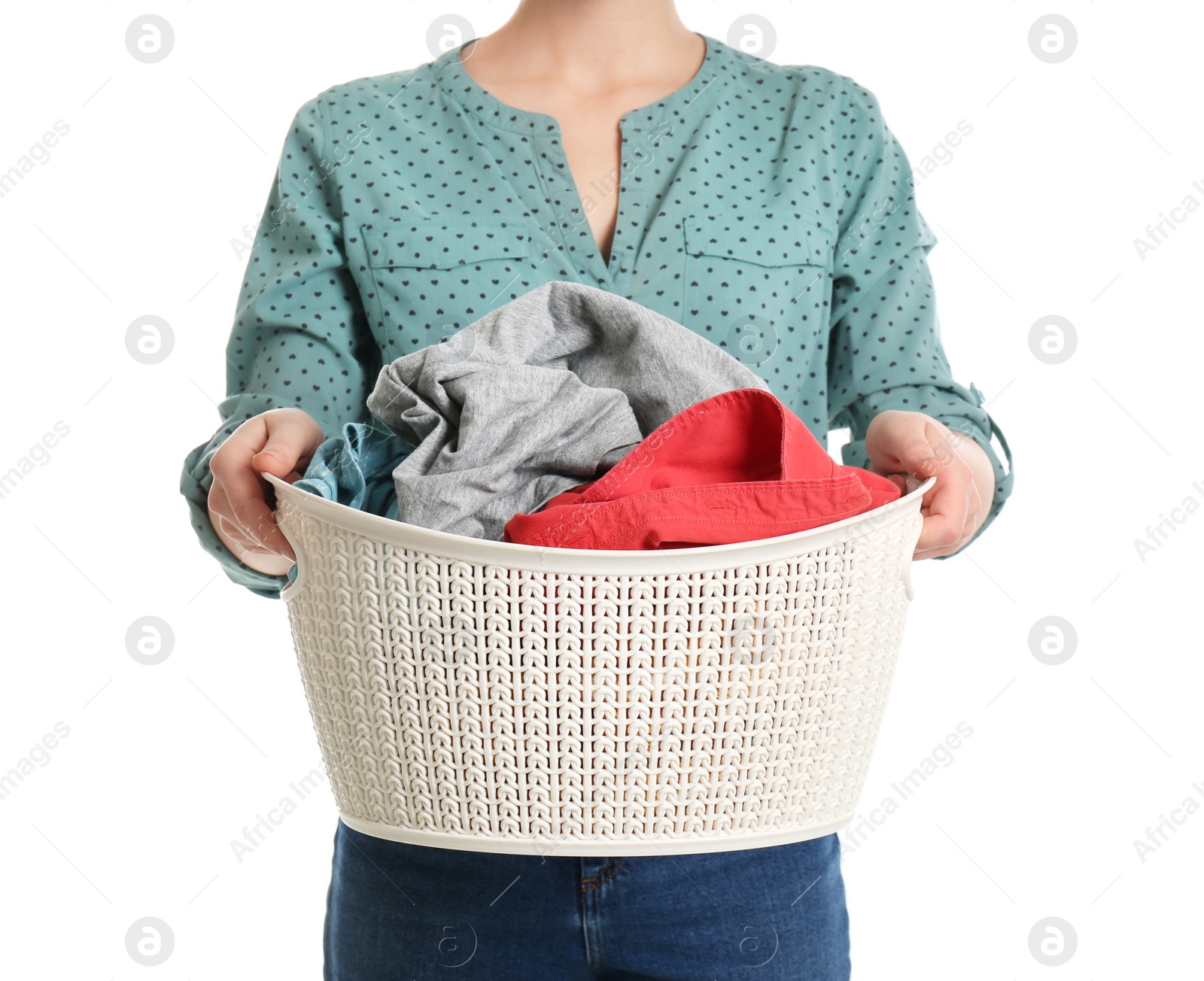 Photo of Young woman holding laundry basket with clothes on white background, closeup