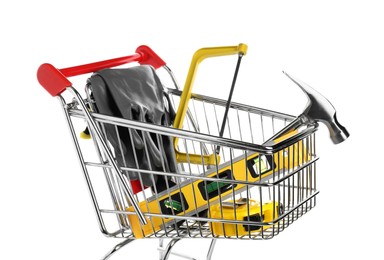 Photo of Small shopping cart with set of construction tools and gloves isolated on white
