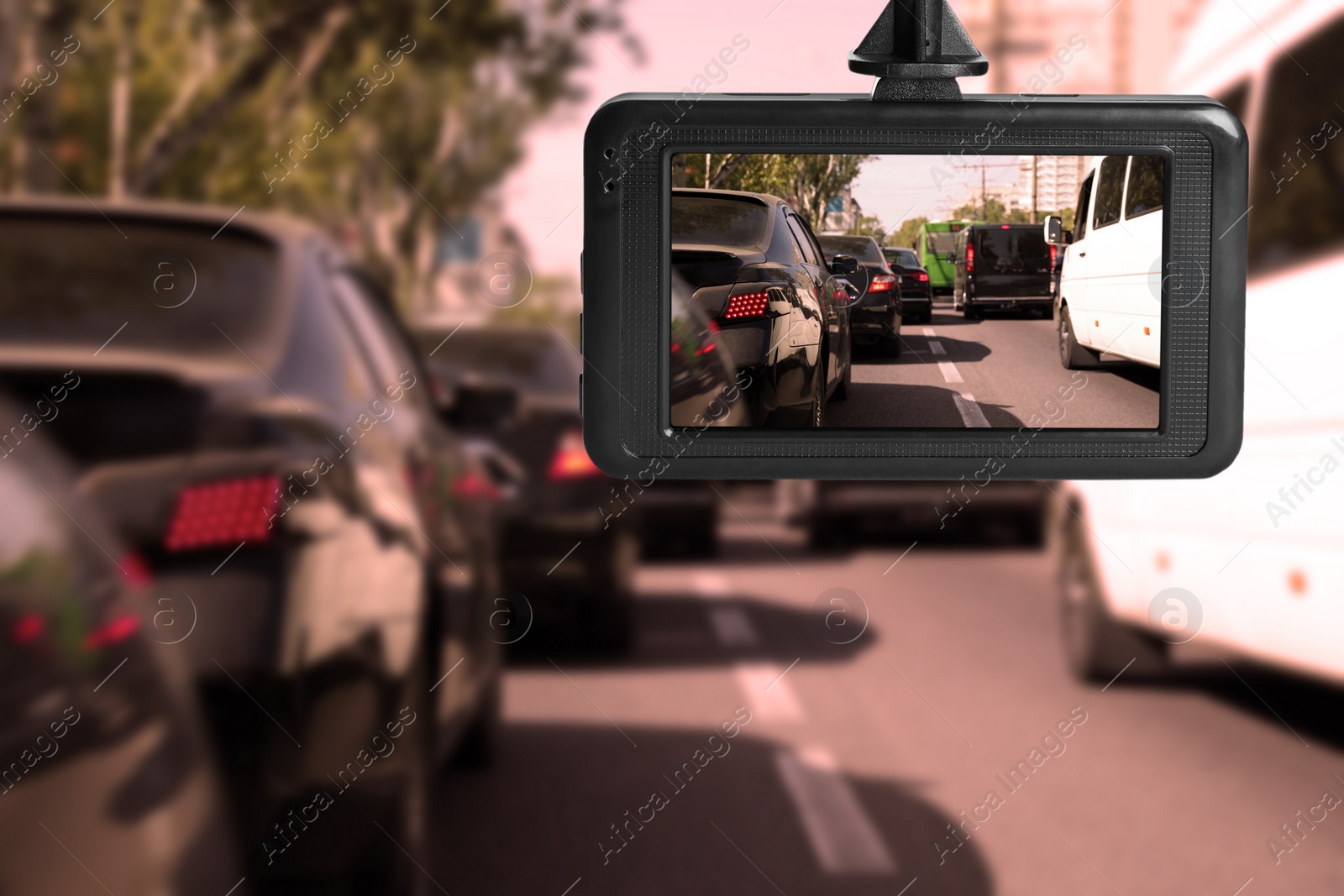 Image of Modern dashboard camera mounted in car, view of road during driving