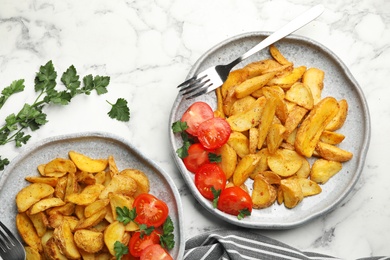 Photo of Delicious oven baked potatoes served on table, flat lay