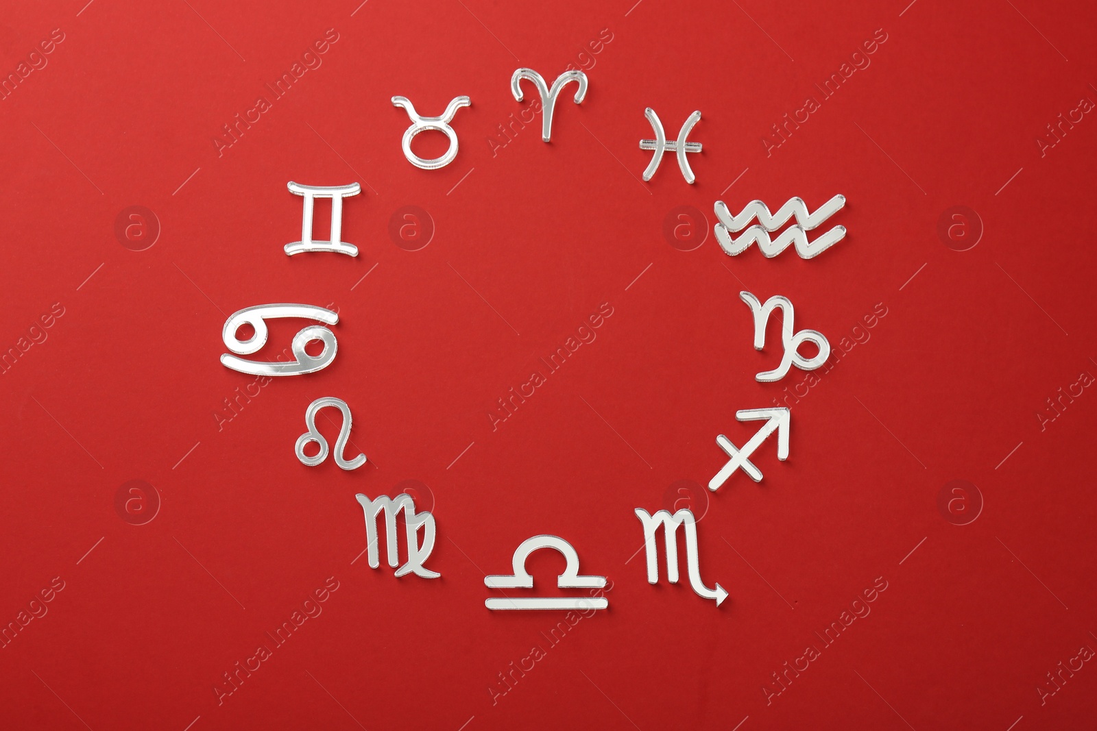 Photo of Zodiac signs on red background, flat lay. Space for text