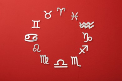 Photo of Zodiac signs on red background, flat lay. Space for text