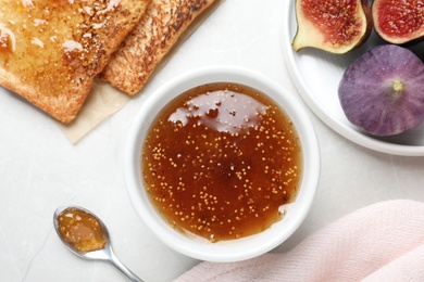 Photo of Flat lay composition with delicious fig jam on light grey table