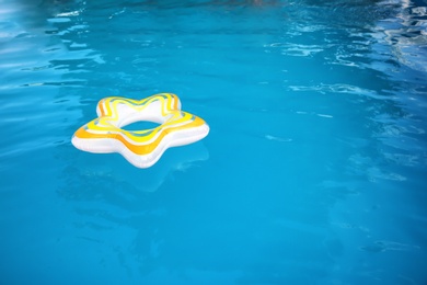 Photo of Inflatable ring floating in swimming pool on sunny day