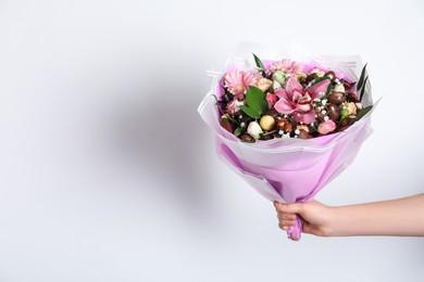 Photo of Woman with beautiful edible bouquet on white background, closeup. Space for text