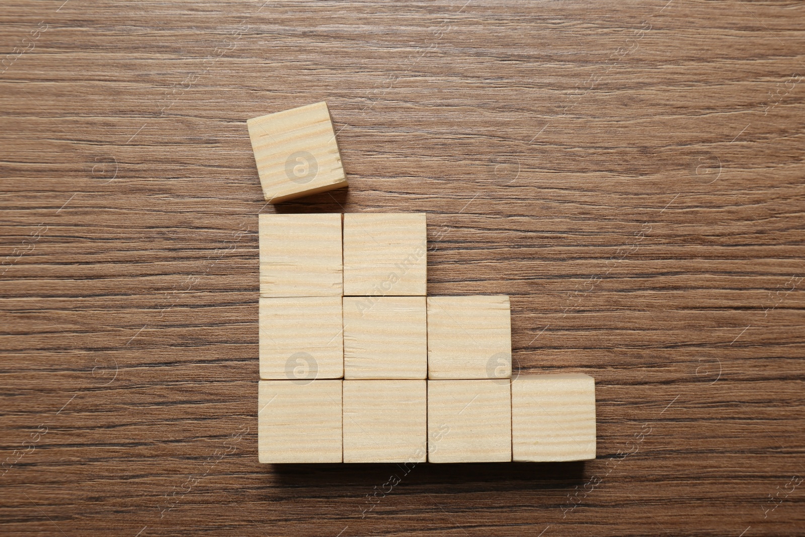 Photo of Blank cubes on wooden table, flat lay with space for text. Idea concept