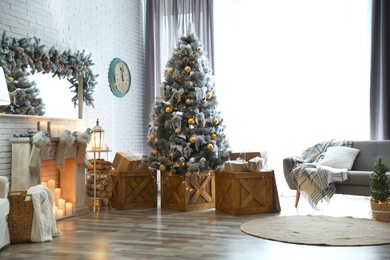 Stylish interior with decorated Christmas tree in living room