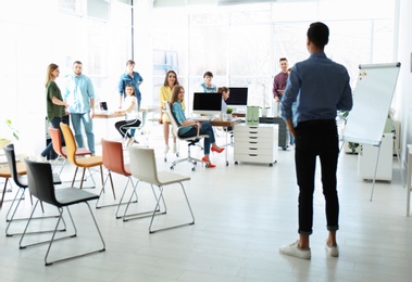 Photo of Male business trainer giving lecture in office