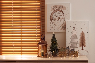 Photo of Beautiful Christmas pictures in decorated room. Interior design