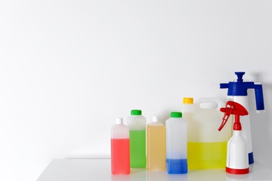 Set of different detergents on table against white background. Space for text