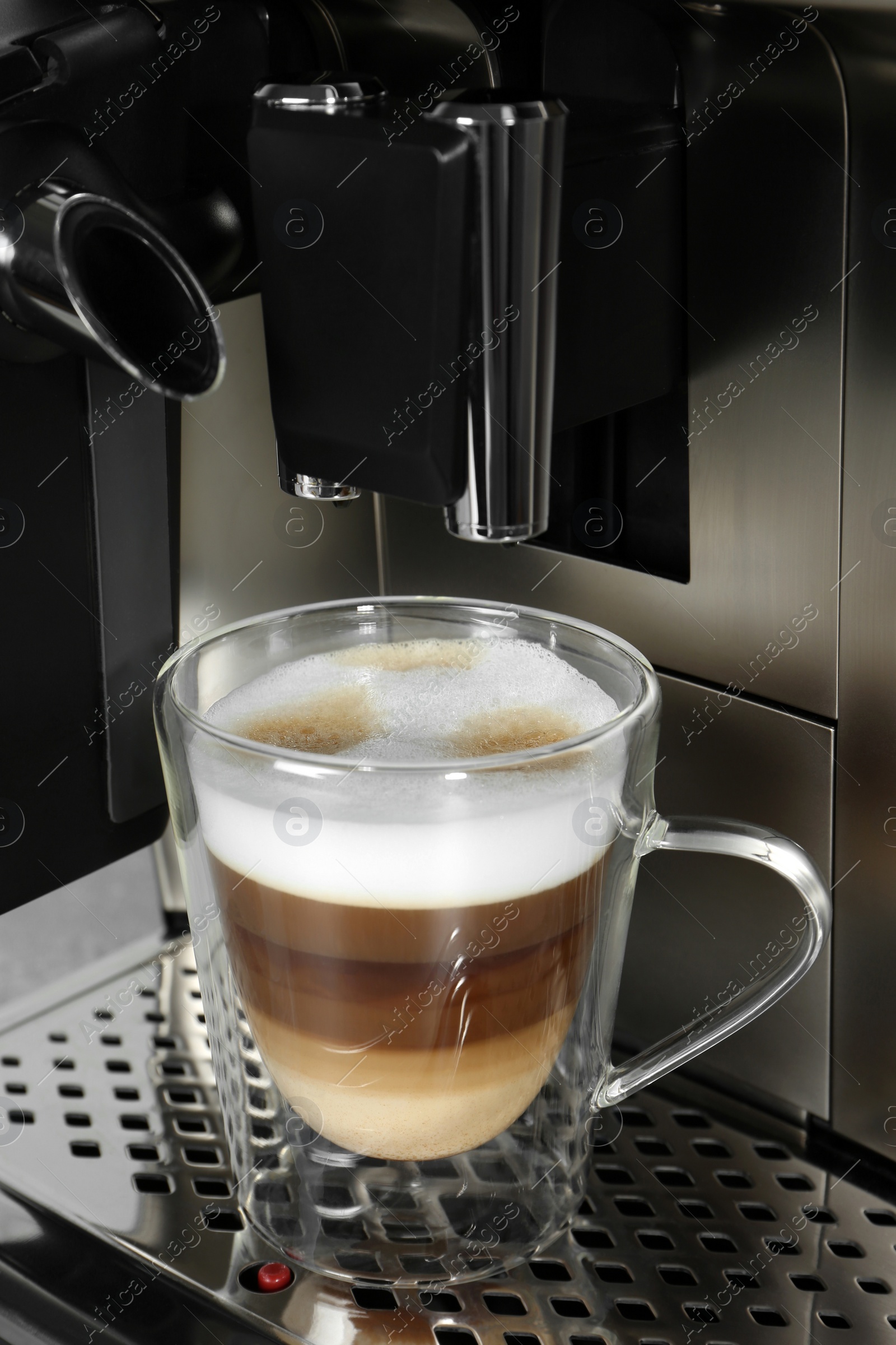 Photo of Modern coffee machine with glass cup of latte, closeup