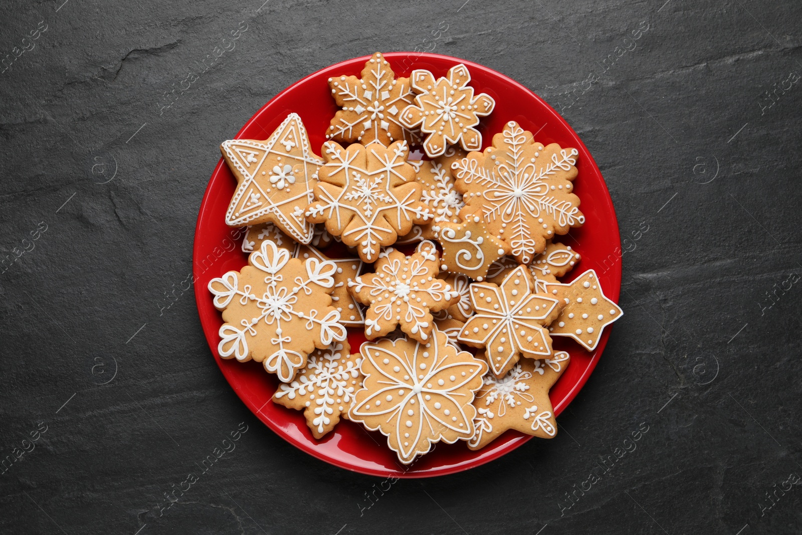 Photo of Tasty Christmas cookies on black table, top view