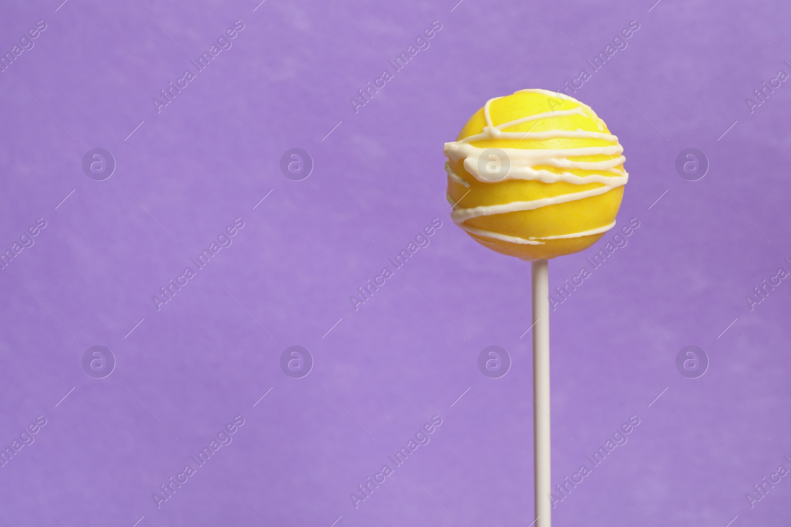 Photo of Bright delicious cake pop on color background. Space for text