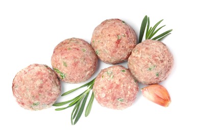 Photo of Many fresh raw meatballs with garlic and rosemary on white background, top view