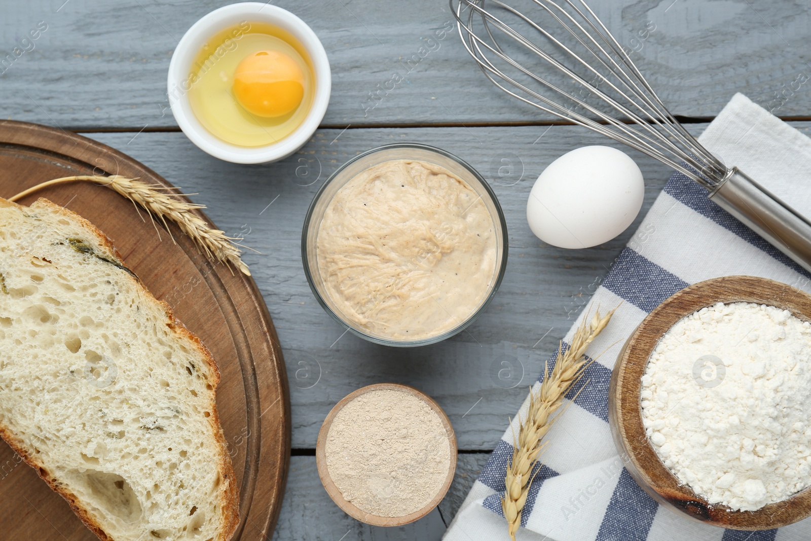 Photo of Flat lay composition with sourdough on grey wooden table