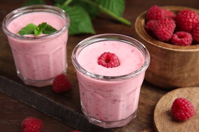 Photo of Tasty fresh raspberry smoothie on wooden table