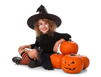 Photo of Cute little girl wearing Halloween costume and pumpkins on white background