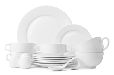 Photo of Set of clean dishware isolated on white