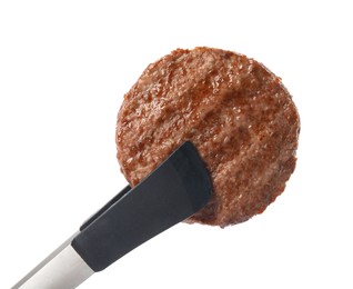 Photo of Tongs with tasty grilled hamburger patty on white background