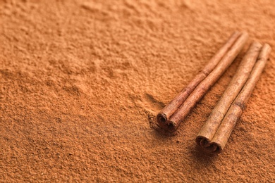 Photo of Aromatic cinnamon powder and sticks, closeup