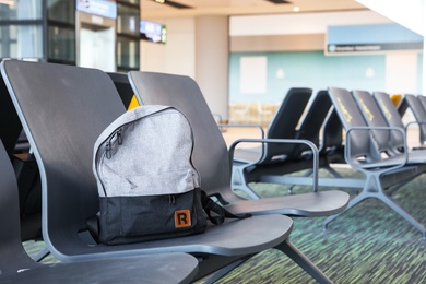 Photo of ISTANBUL, TURKEY - AUGUST 13, 2019: Backpack on seat in waiting area of new airport terminal
