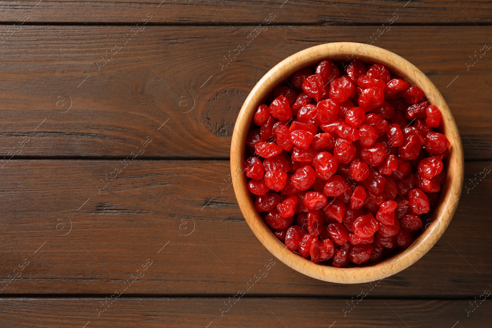 Photo of Bowl of sweet cherries on table, top view with space for text. Dried fruit as healthy snack