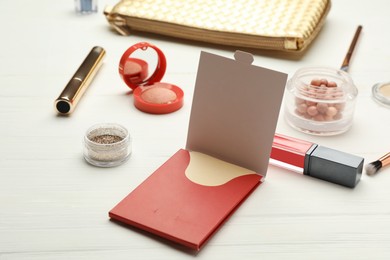Facial oil blotting tissues and different decorative cosmetics on white wooden table. Mattifying wipes