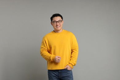 Photo of Portrait of happy man on grey background. Space for text