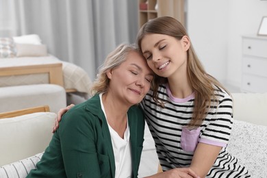 Photo of Young woman with her mom at home. Happy Mother's Day