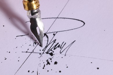 Photo of Signing on sheet of paper with fountain pen, closeup