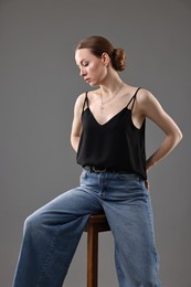Photo of Fashionable portrait of beautiful young woman on grey background