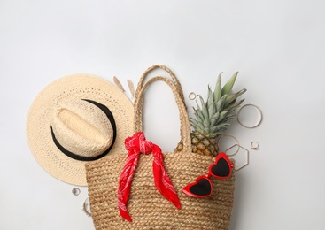 Photo of Stylish straw bag and summer accessories on white background, flat lay