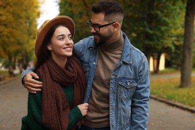 Photo of Happy young couple spending time together in autumn park
